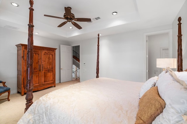 bedroom featuring ceiling fan, recessed lighting, light carpet, visible vents, and a raised ceiling