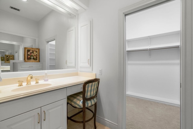 bathroom featuring baseboards, visible vents, and vanity