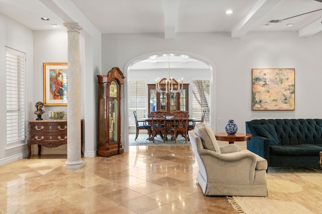 interior space featuring beam ceiling, a notable chandelier, recessed lighting, ornate columns, and baseboards