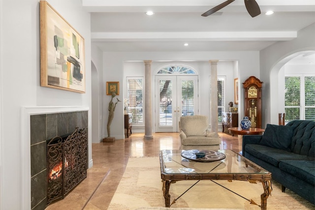 living area with recessed lighting, a fireplace, french doors, beamed ceiling, and ornate columns