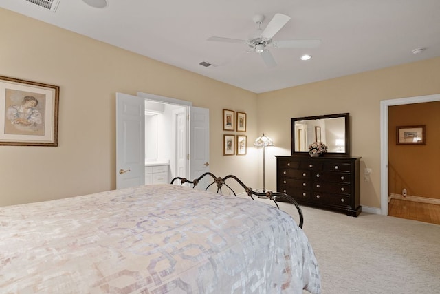 carpeted bedroom featuring baseboards, visible vents, a ceiling fan, ensuite bathroom, and recessed lighting