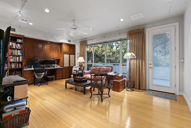 home office featuring light wood finished floors, visible vents, built in study area, ceiling fan, and recessed lighting