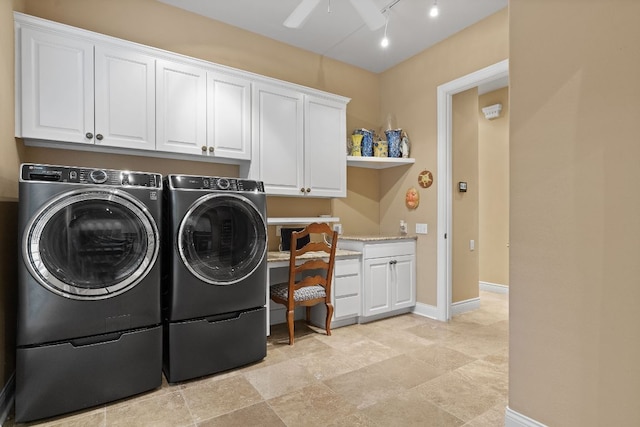 clothes washing area featuring rail lighting, cabinet space, a ceiling fan, separate washer and dryer, and baseboards