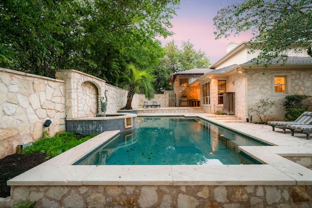 outdoor pool with a patio area