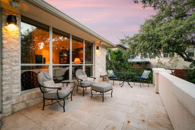 view of patio terrace at dusk