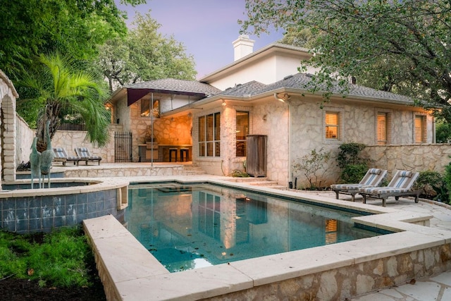 pool featuring fence and a patio