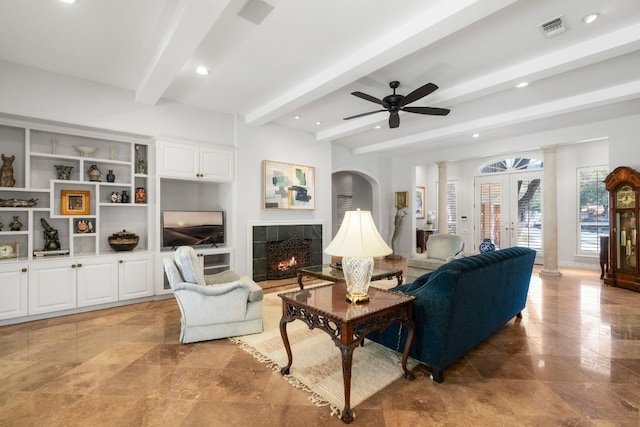 living area featuring beam ceiling, french doors, a fireplace, visible vents, and ceiling fan