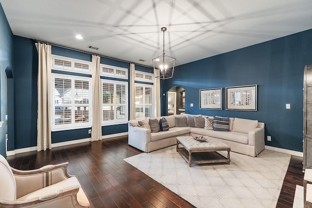 living room with a notable chandelier and wood-type flooring