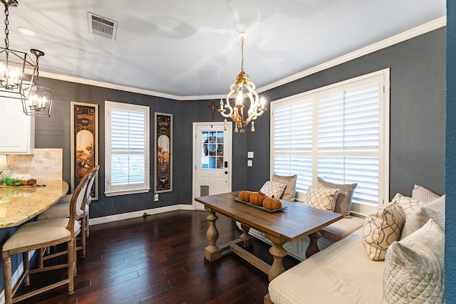 dining space featuring crown molding, a notable chandelier, and dark hardwood / wood-style flooring