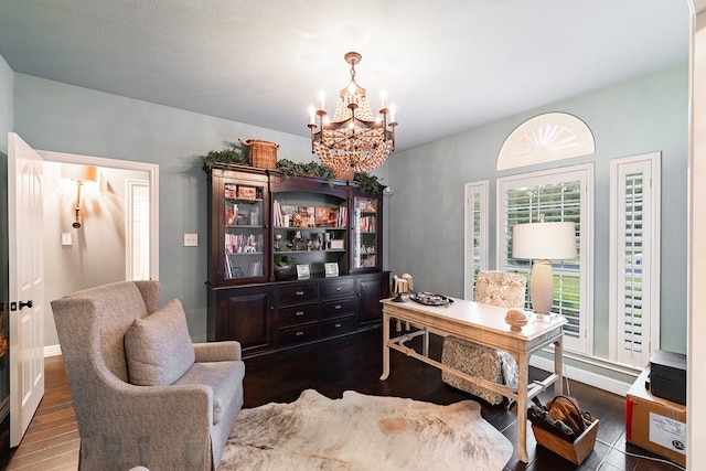 office with a chandelier and dark hardwood / wood-style flooring