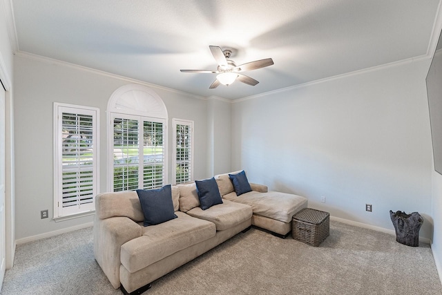 carpeted living room featuring ceiling fan and ornamental molding