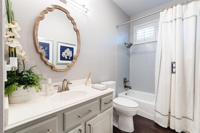 full bathroom with hardwood / wood-style floors, toilet, shower / tub combo with curtain, and vanity