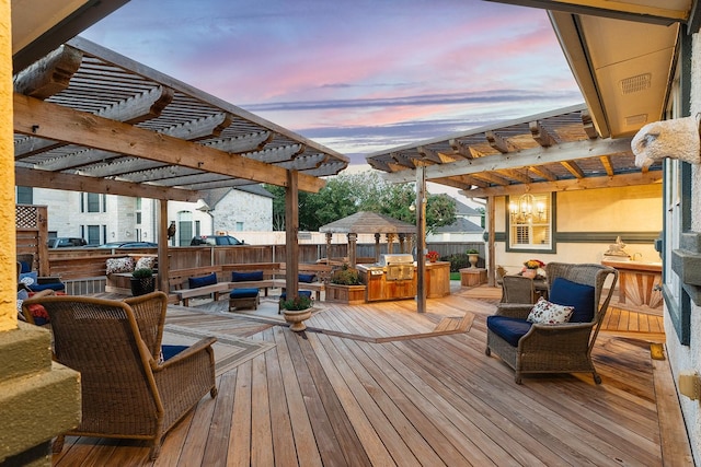 deck at dusk with outdoor lounge area and a pergola