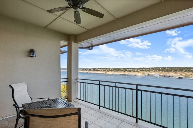 balcony with a water view and ceiling fan