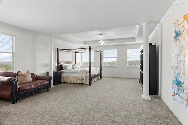 carpeted bedroom with ornate columns, ceiling fan, ornamental molding, and multiple windows