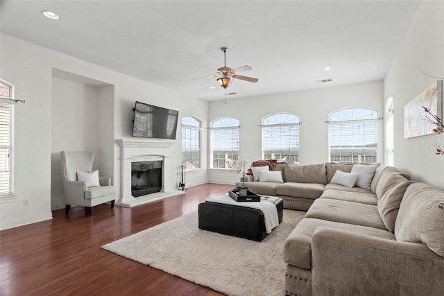 living room featuring ceiling fan and dark hardwood / wood-style flooring