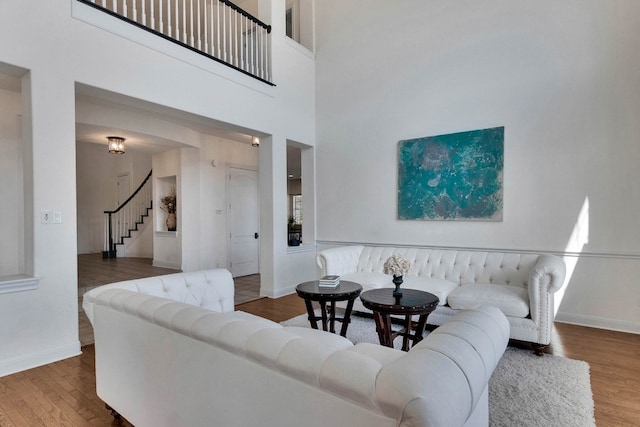 living room featuring hardwood / wood-style floors and a towering ceiling