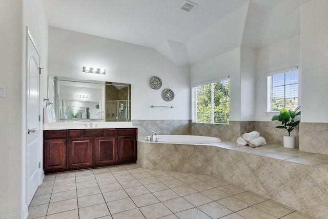 bathroom with vanity, tile patterned flooring, separate shower and tub, and vaulted ceiling