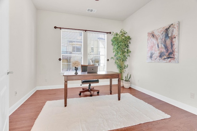 home office with hardwood / wood-style flooring