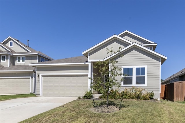 view of front of property with a front lawn and a garage