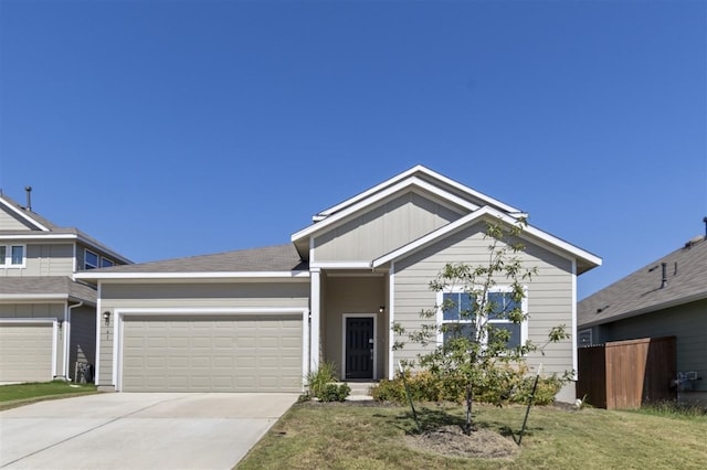 view of front of home featuring a front lawn and a garage