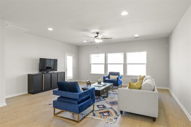 living room with ceiling fan and light wood-type flooring