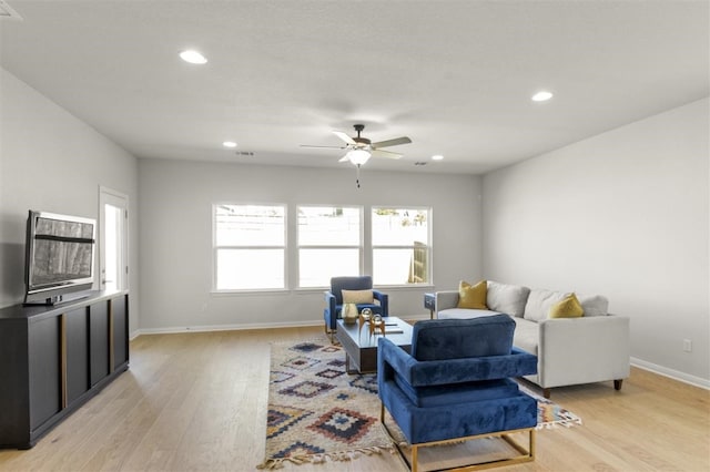 living room with light wood-type flooring and ceiling fan