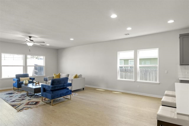 living room featuring ceiling fan and light hardwood / wood-style flooring