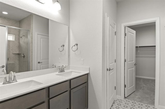 bathroom with vanity and a shower with shower door