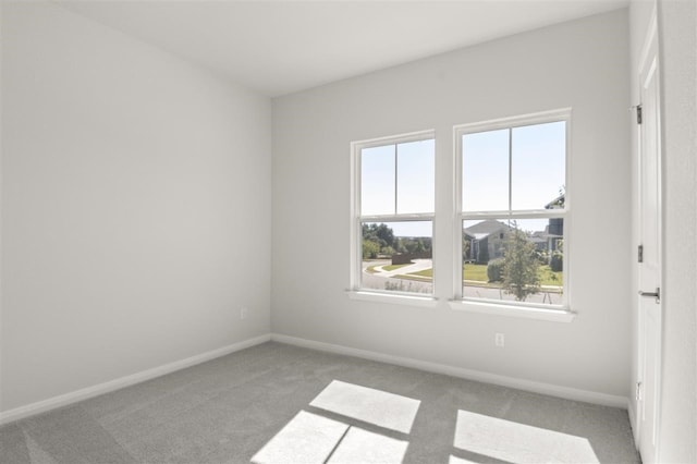 carpeted spare room with a healthy amount of sunlight