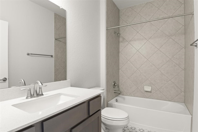 full bathroom featuring vanity, tiled shower / bath combo, and toilet