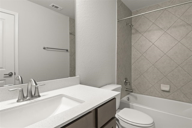 full bathroom with vanity, toilet, and tiled shower / bath