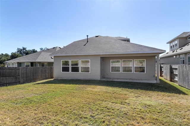 back of property featuring a lawn