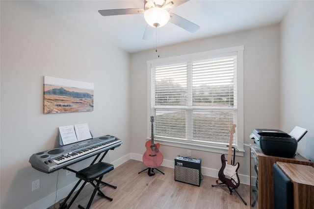 interior space featuring baseboards, ceiling fan, and wood finished floors
