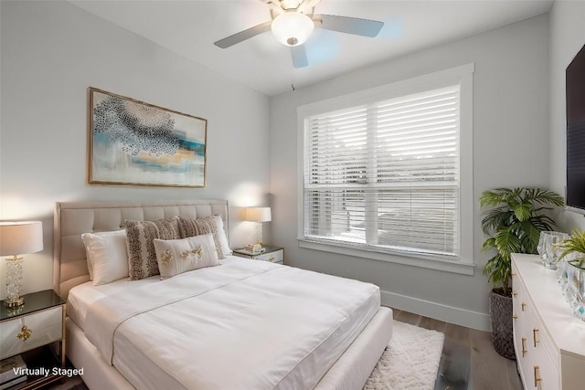 bedroom with baseboards, a ceiling fan, and wood finished floors