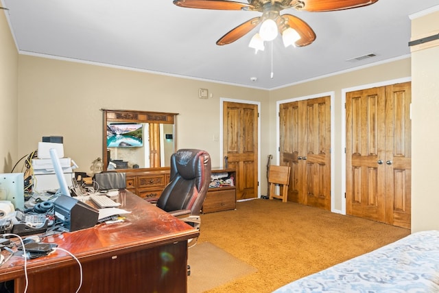 home office featuring crown molding, light colored carpet, and ceiling fan