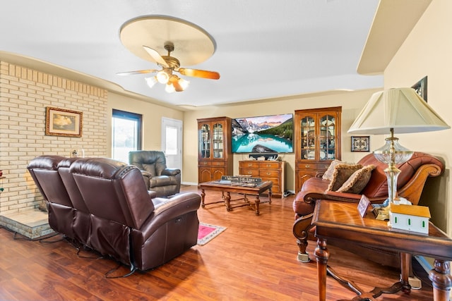 living room with wood-type flooring and ceiling fan