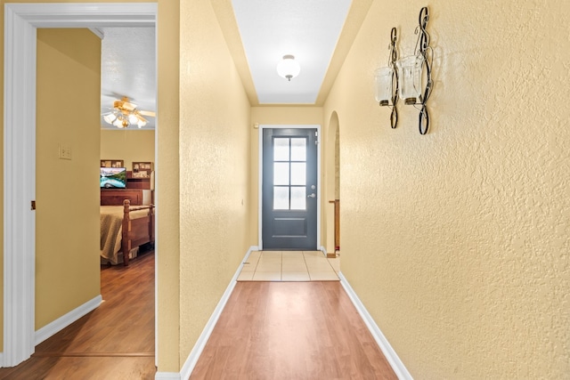 doorway featuring ceiling fan and light wood-type flooring