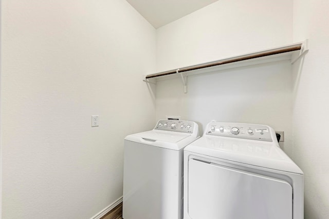 laundry room featuring hardwood / wood-style floors and washer and dryer