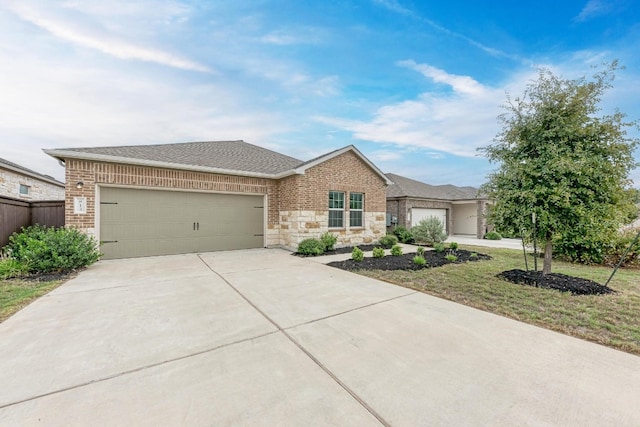 view of front facade featuring a front yard and a garage