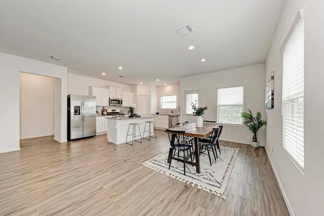 dining area featuring light wood-type flooring