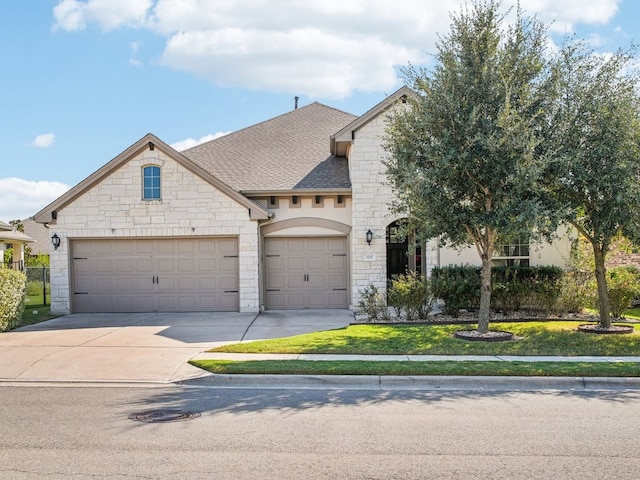 french country style house with a garage and a front lawn