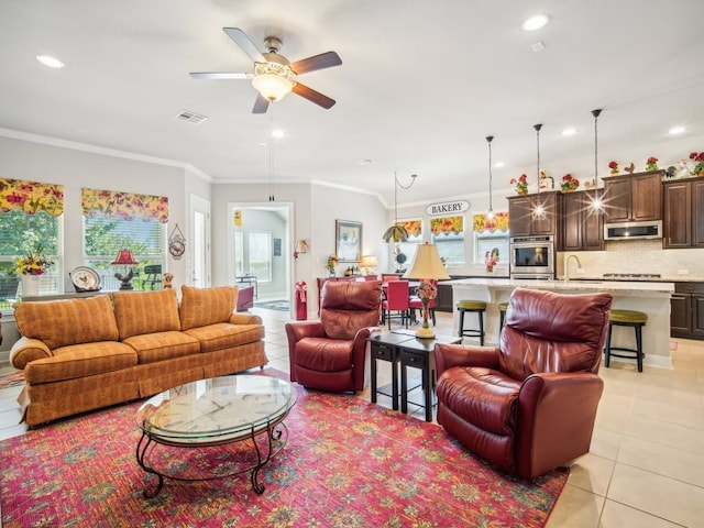 tiled living room featuring ceiling fan, ornamental molding, and sink