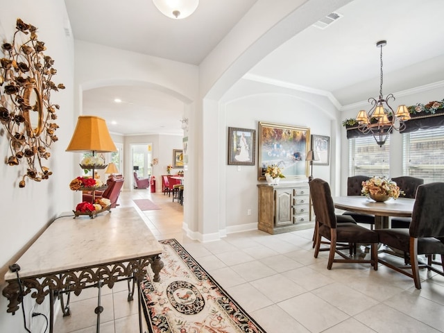 dining area featuring a wealth of natural light, light tile patterned flooring, ornamental molding, and an inviting chandelier