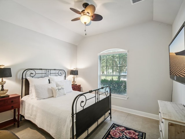 bedroom featuring ceiling fan, light tile patterned flooring, and vaulted ceiling