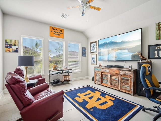 living room with tile patterned flooring, vaulted ceiling, a wealth of natural light, and ceiling fan