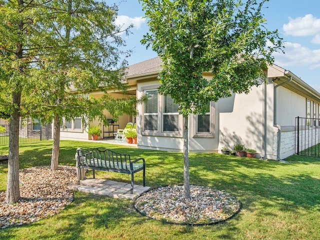 back of house featuring a lawn