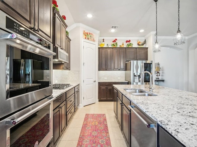 kitchen with appliances with stainless steel finishes, dark brown cabinets, crown molding, sink, and light tile patterned floors