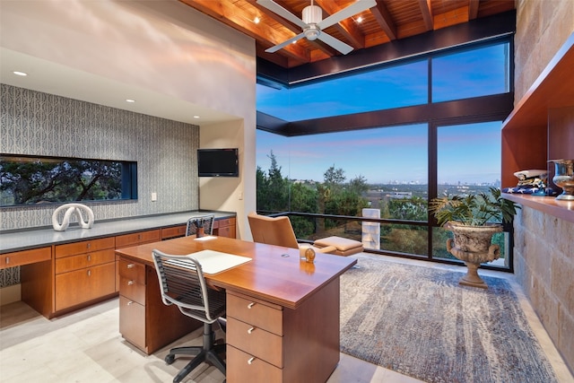 office area featuring beamed ceiling, wood ceiling, and ceiling fan