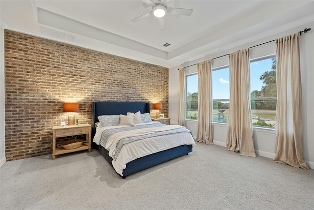 carpeted bedroom with brick wall and ceiling fan